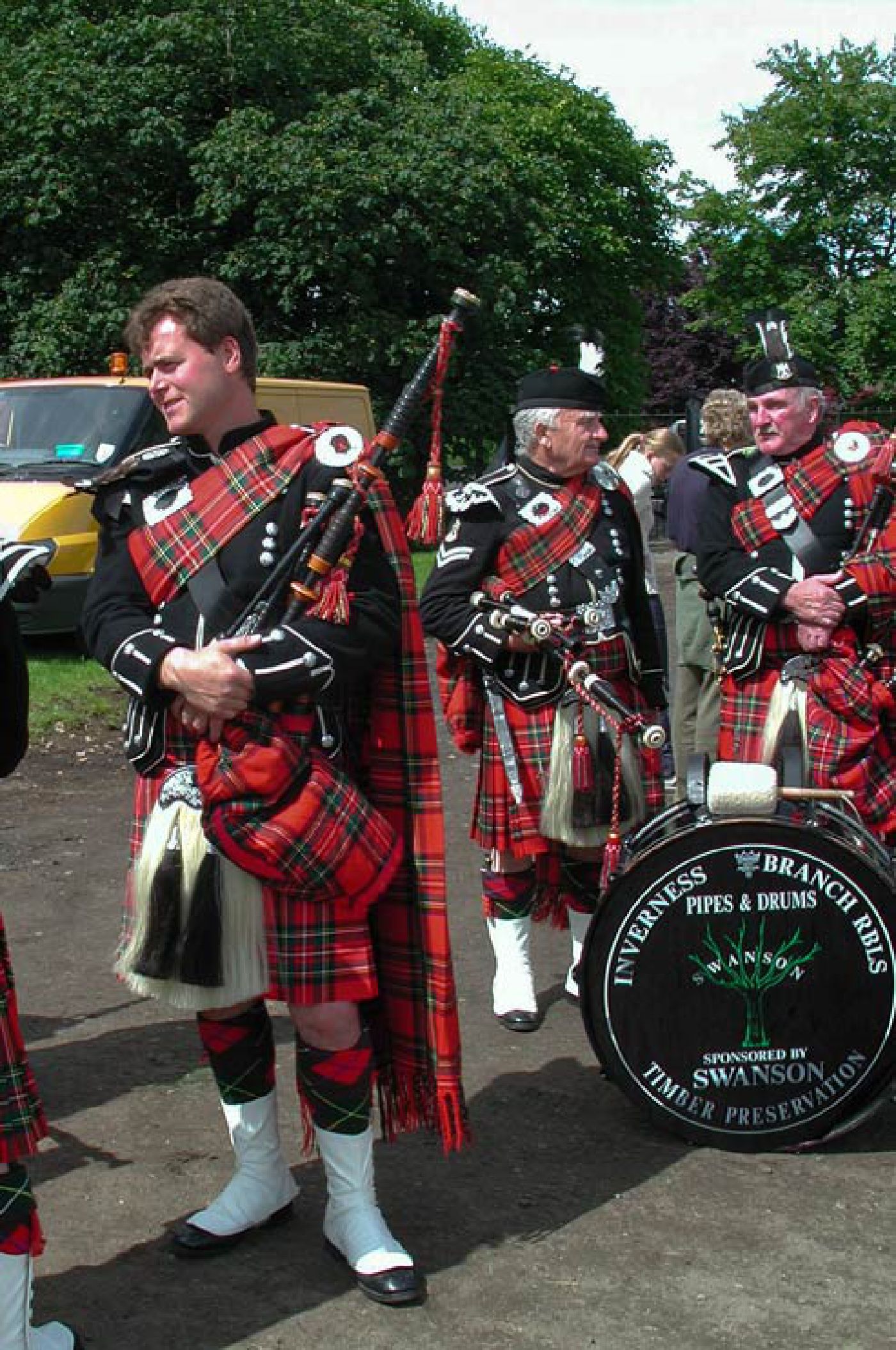 Scottish piper with pipe band